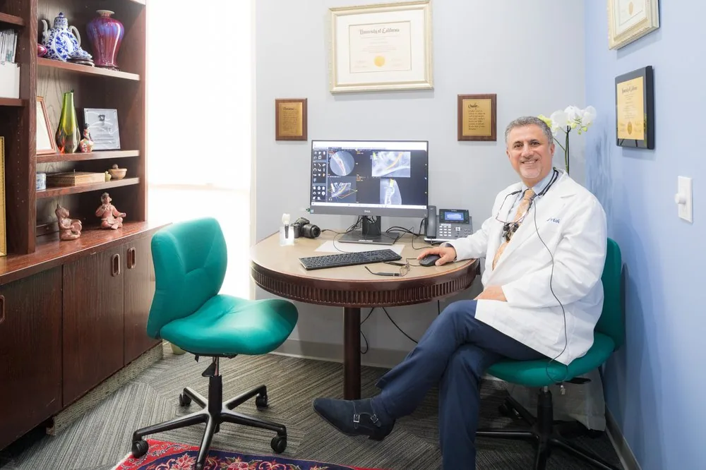 Dr. Darvish reviewing dental implant imaging and treatment planning at Walnut Creek Dental